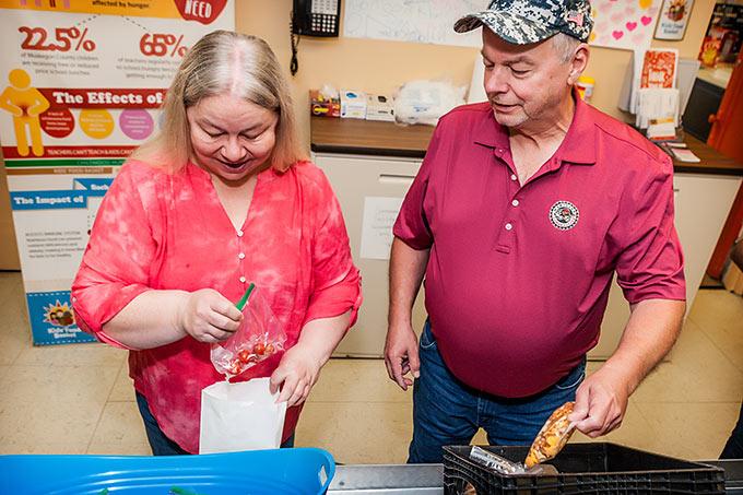 Woman and Man Filling Lunch Bags