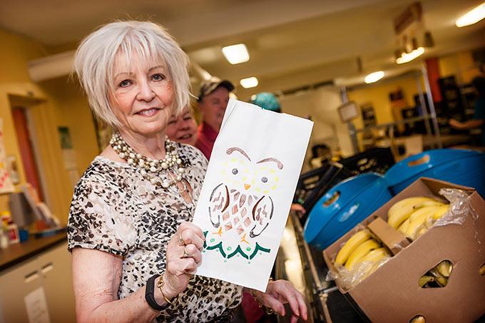 Woman holding decorated lunch bag